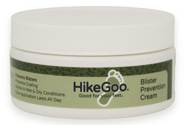 A white plastic jar of HikeGoo Blister Prevention Cream with a green label, featuring the hikegoo footprint logo and text that reads “Good for your feet” and “Prevents blisters and chafing.”.