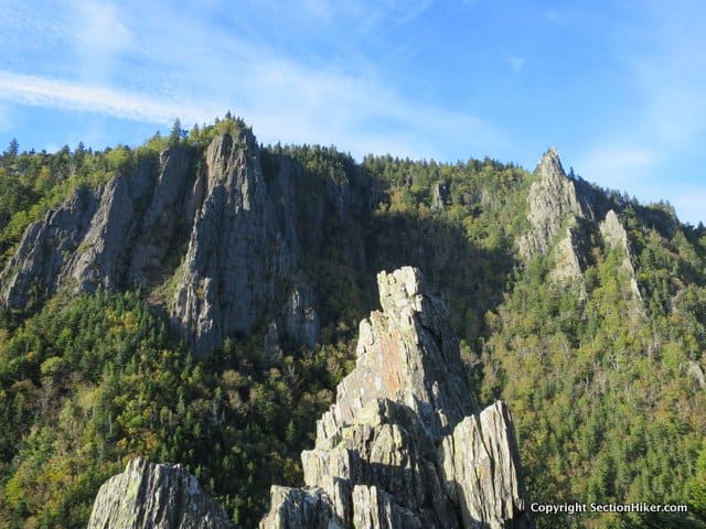 Jagged rock formations in Dixville Notch. The rock spire in the foreground is on the north side of the pass, while the two rear spires are on the south side.