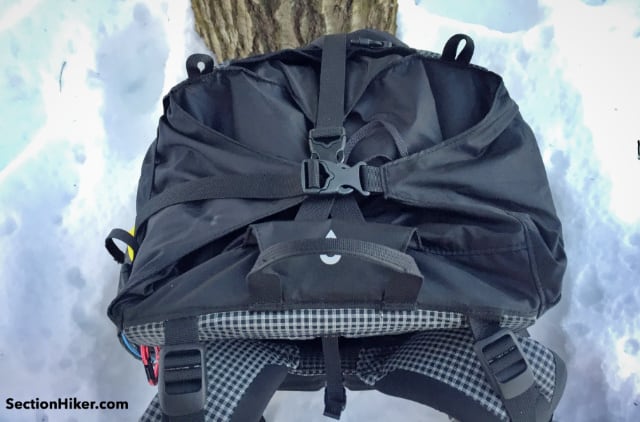 Two webbing straps, one front-to-back and the other side-to-side cover the main compartment and prevent rain from entering. 