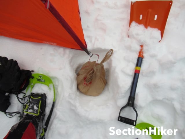 Plastic shopping bags make excellent snow anchors. Just be sure to dig them out when you pack up.