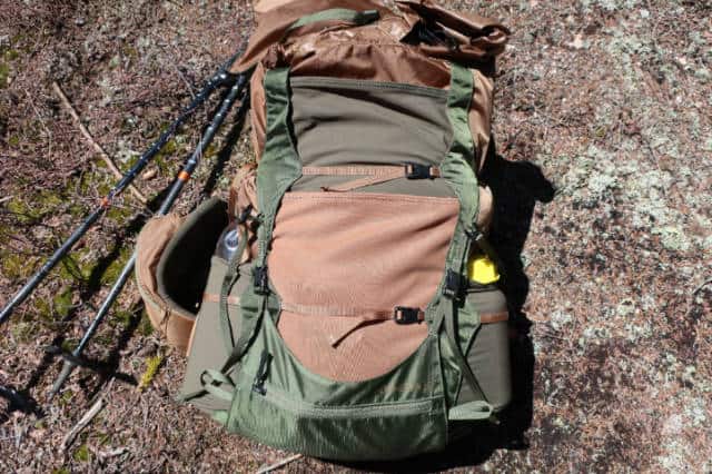 There are two stretch mesh pockets on the front of the pack, one beige and one green above it.