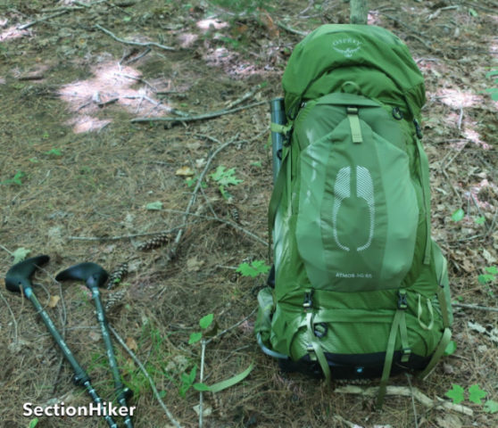 The Atmos has a conventional layout with a top lid, open front pocket, sleeping bag compartment, and side water bottle pockets