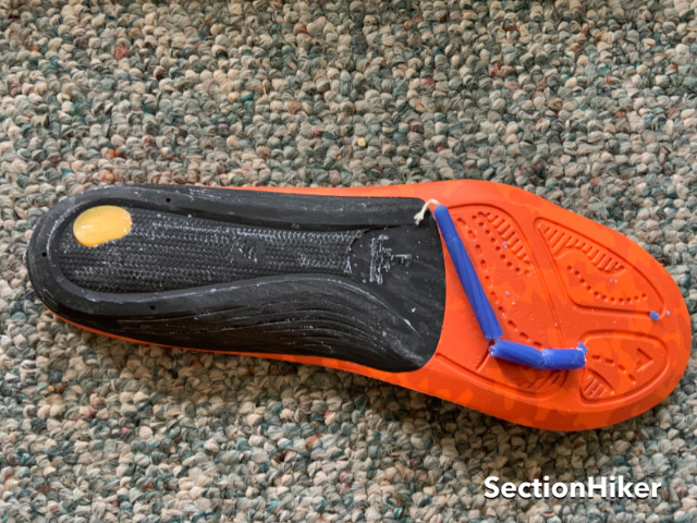 Rub the candle wax into the firm heel part of the insole to stop it from squeaking.