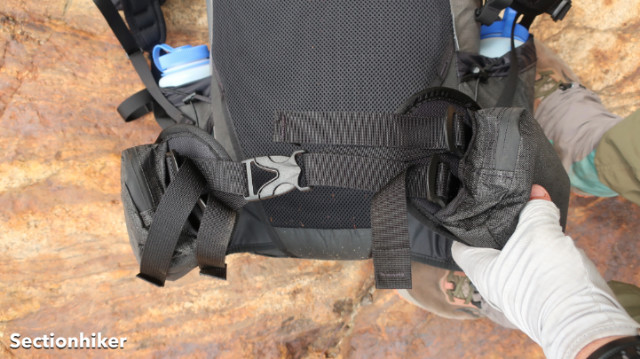The hip belt is adjusted with a top and bottom strap