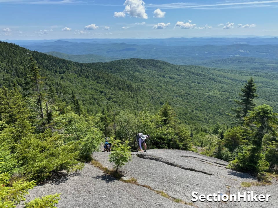 The Middlesex Trail climbs up vast expenses of ledge with distance views of the White Mountains.