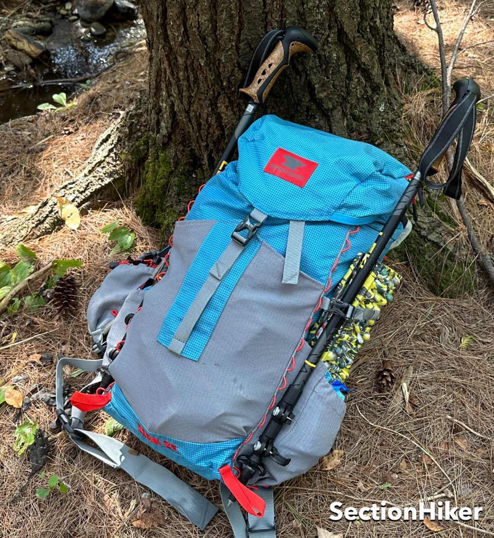 Red daisy chains around the pack perimeter let you hand items or secure trekking pole tips.