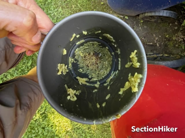 Bunred food in a camp cook pot.